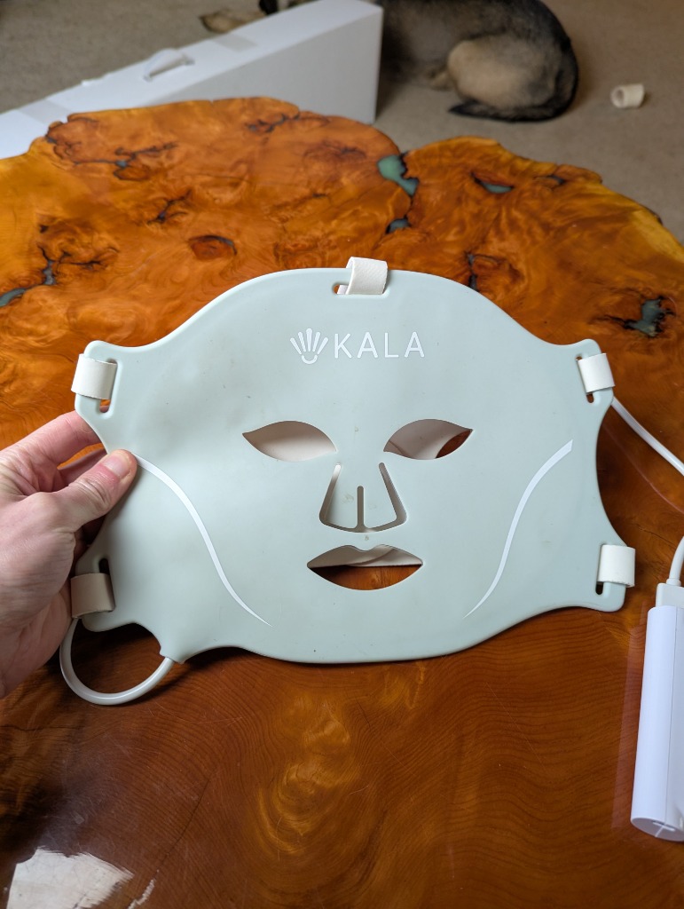 Holding the flexible Kala Red Light Face Mask
